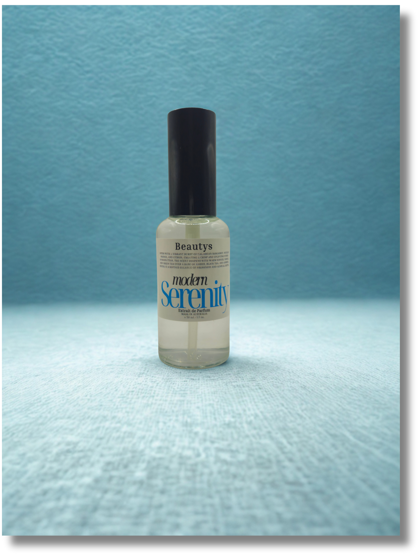 Modern Serenity cologne displayed on dark wood surface, elegant masculine citrus fragrance.