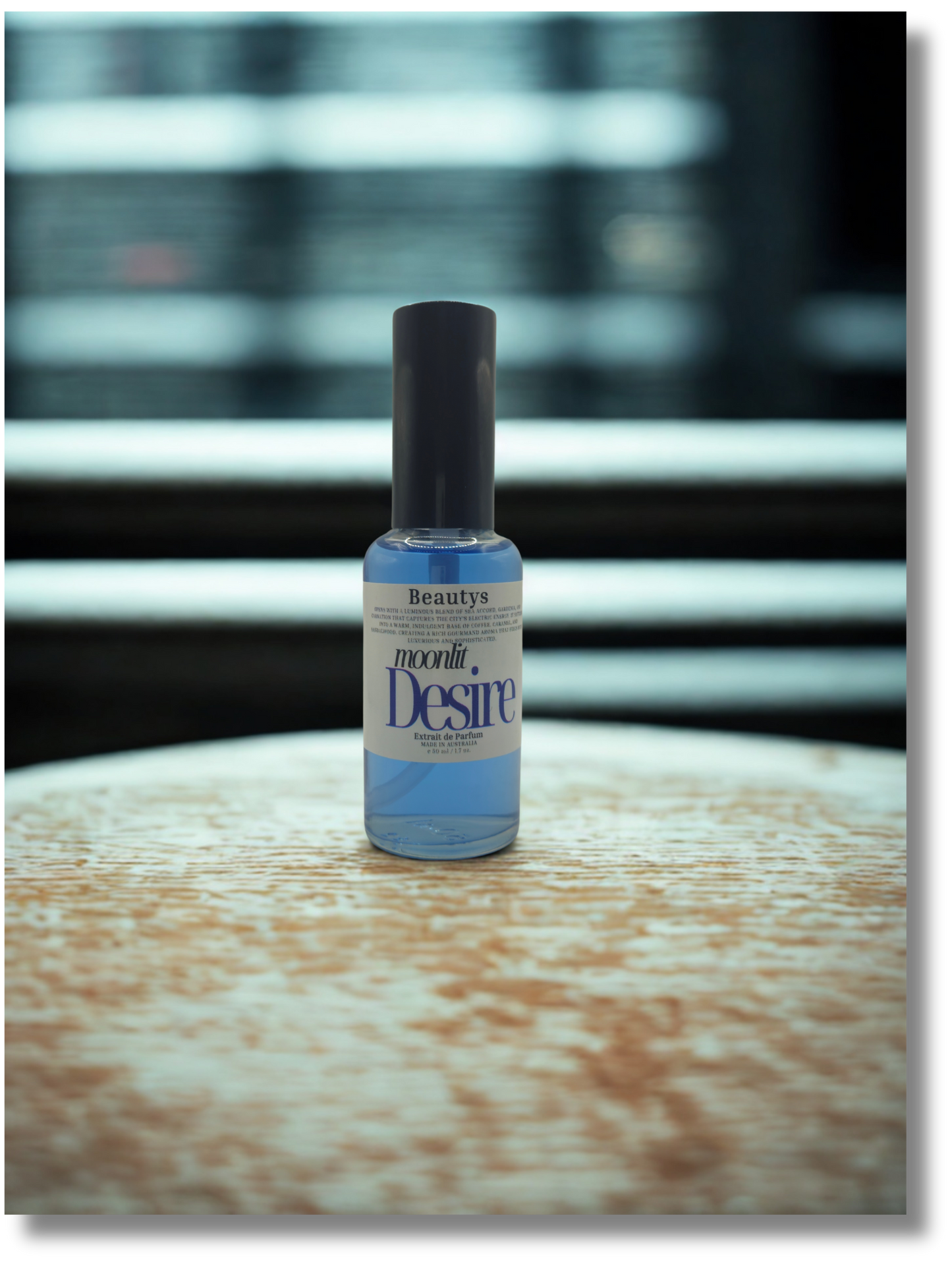 Elegant Moonlit Desire perfume displayed on marble surface, cruelty-free unisex scent.
