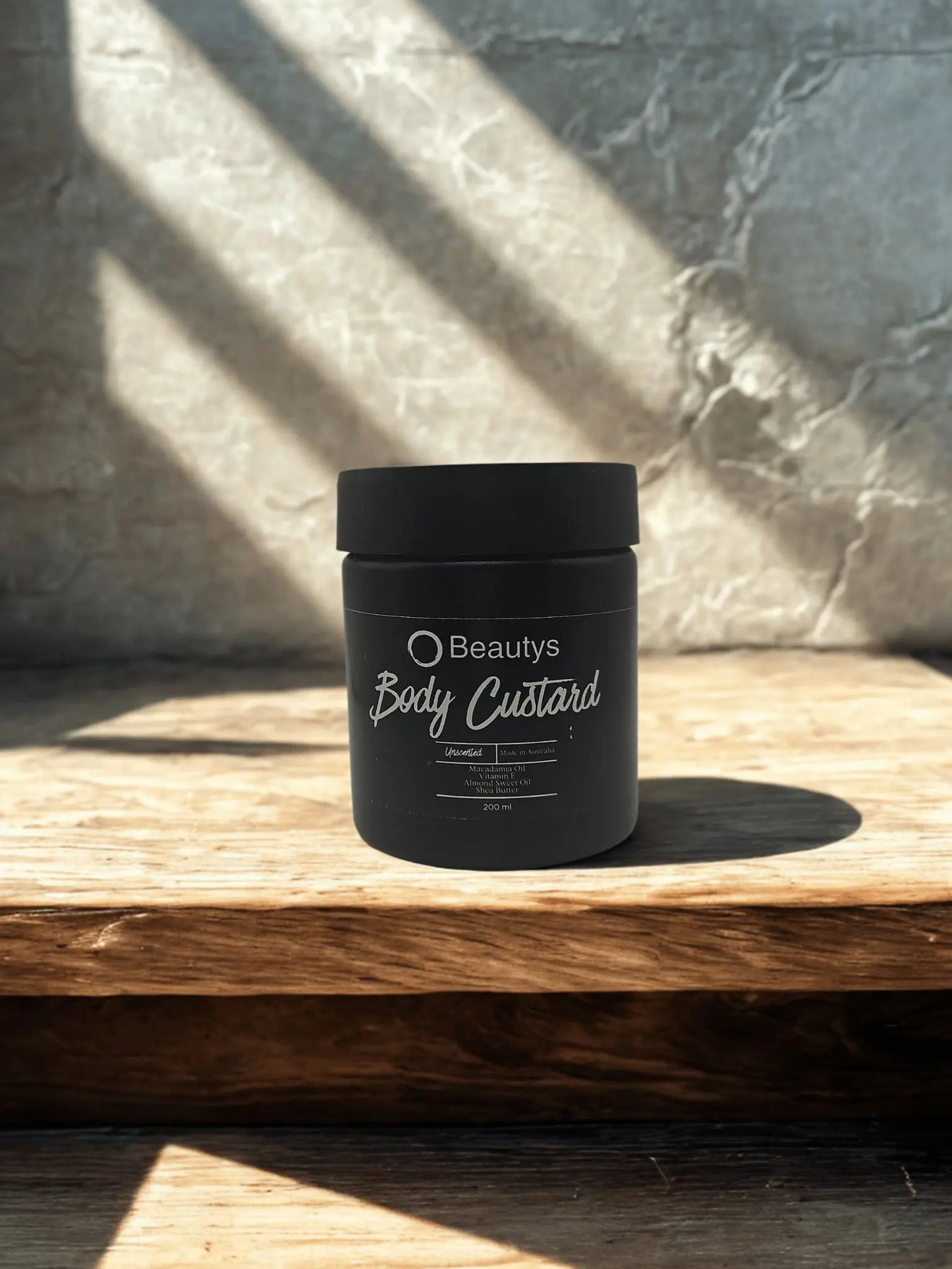 Beautys Luxe Body Custard jar with gold accents, creamy texture visible, luxurious skincare product for soft, hydrated skin.