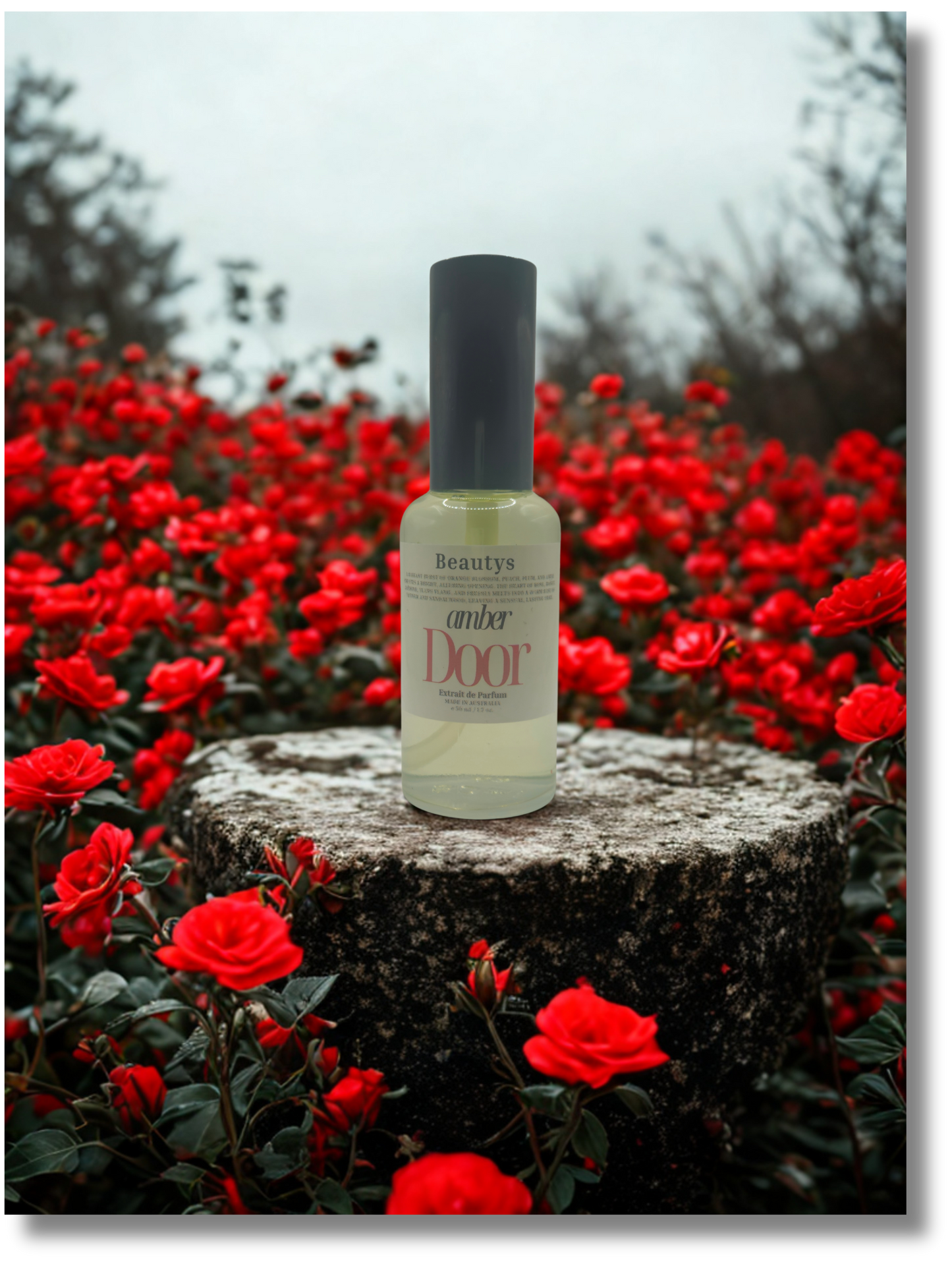 Bottle of 'Beauty Door' product on a stone surface with red flowers in the background