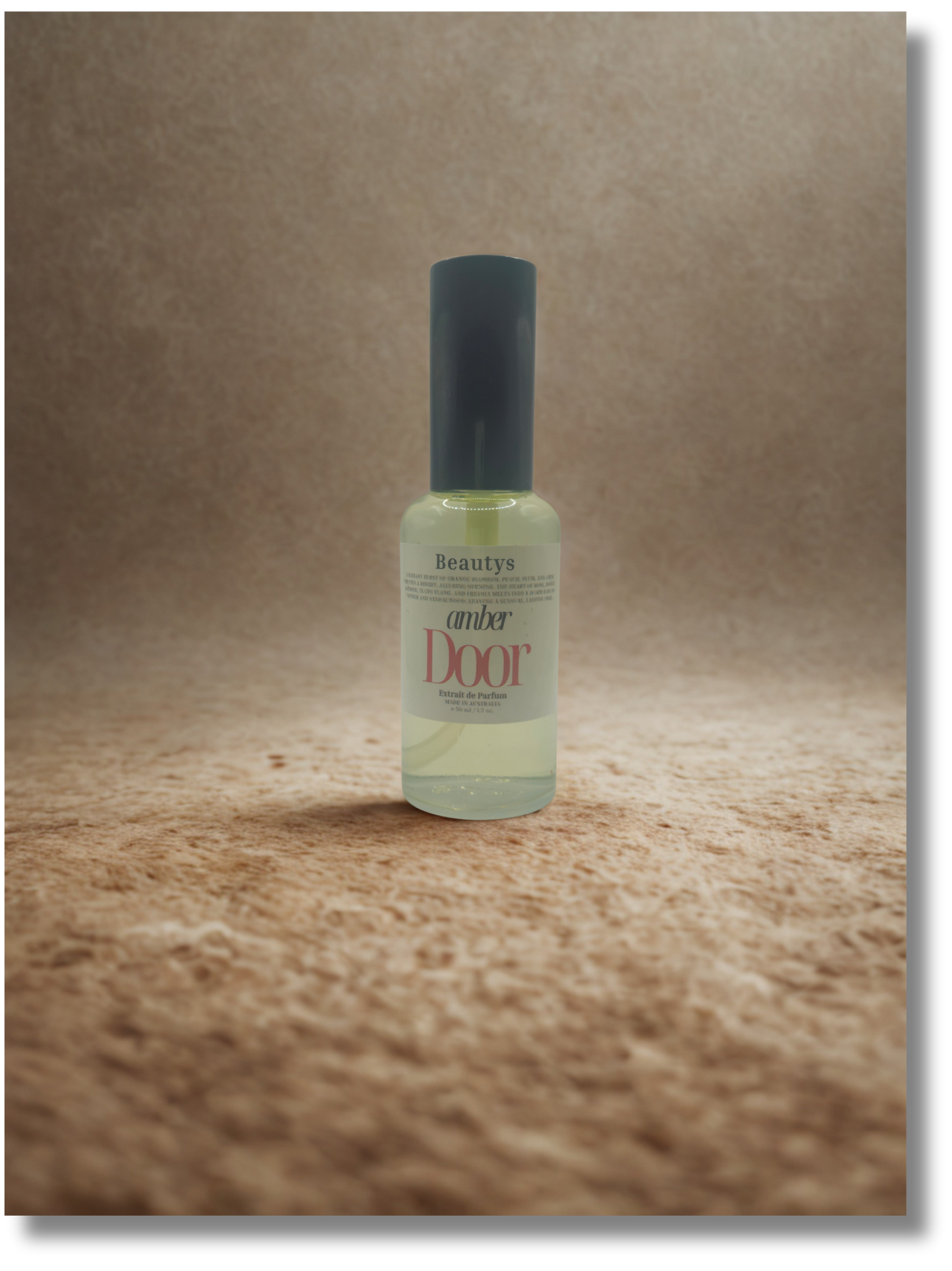 Bottle of 'Beauty's Amber Door' on a textured brown surface