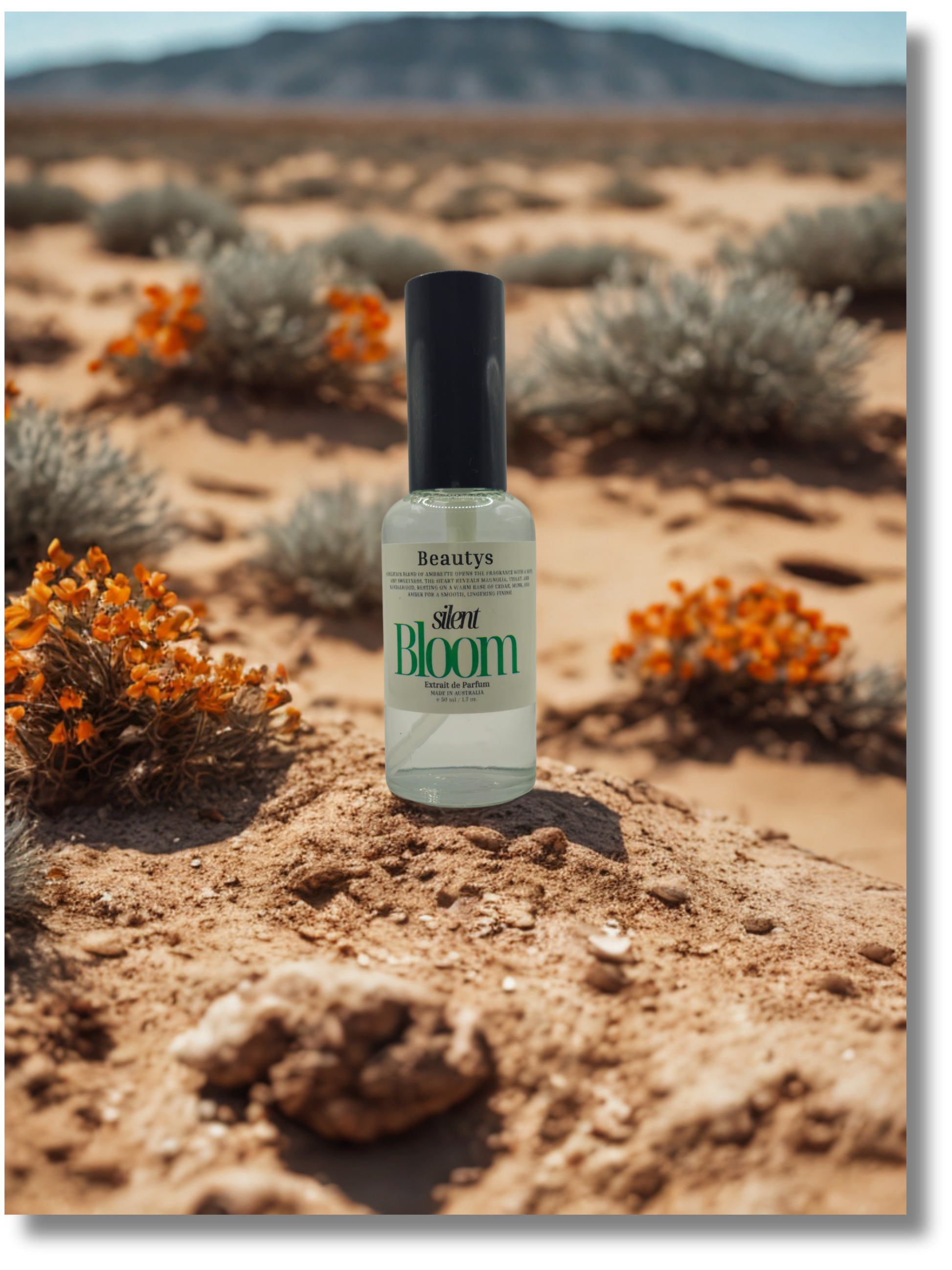 Bottle of 'Silent Bloom' product in a desert setting with desert plants and mountains.