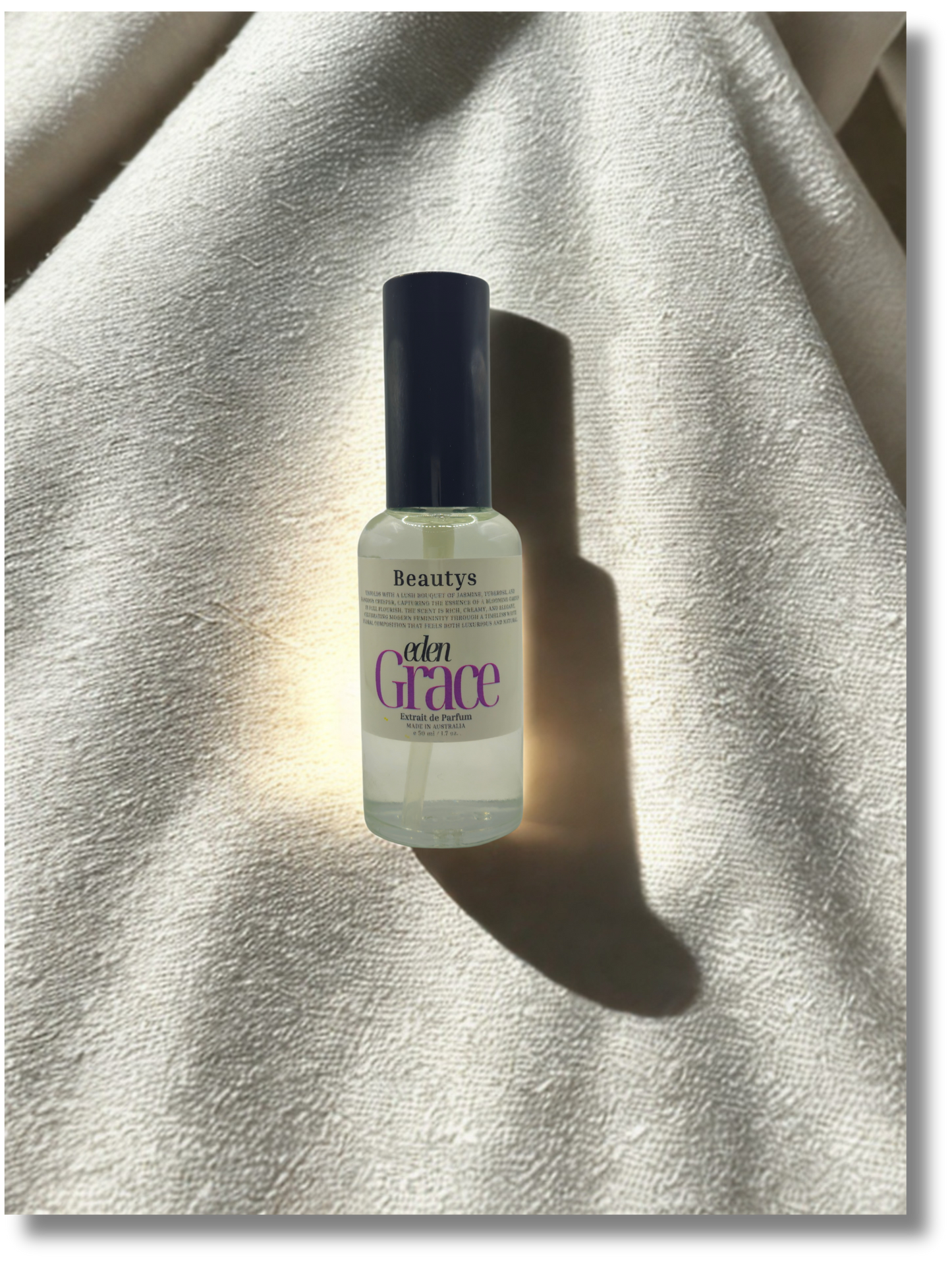 Close-up of Eden Grace perfume bottle, luxury artisan women’s fragrance with jasmine and tuberose.