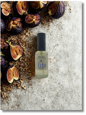Bottle of 'Eclat' with figs and seeds on a textured surface