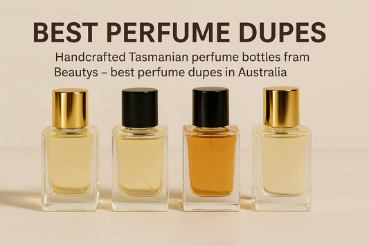 Handcrafted Tasmanian perfume bottles from Beautys displayed in a row with gold and black caps, showcasing the best perfume dupes in Australia on a neutral beige background.