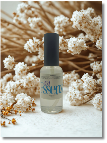 Bottle of Essenz with a black cap on a white surface with dried flowers in the background