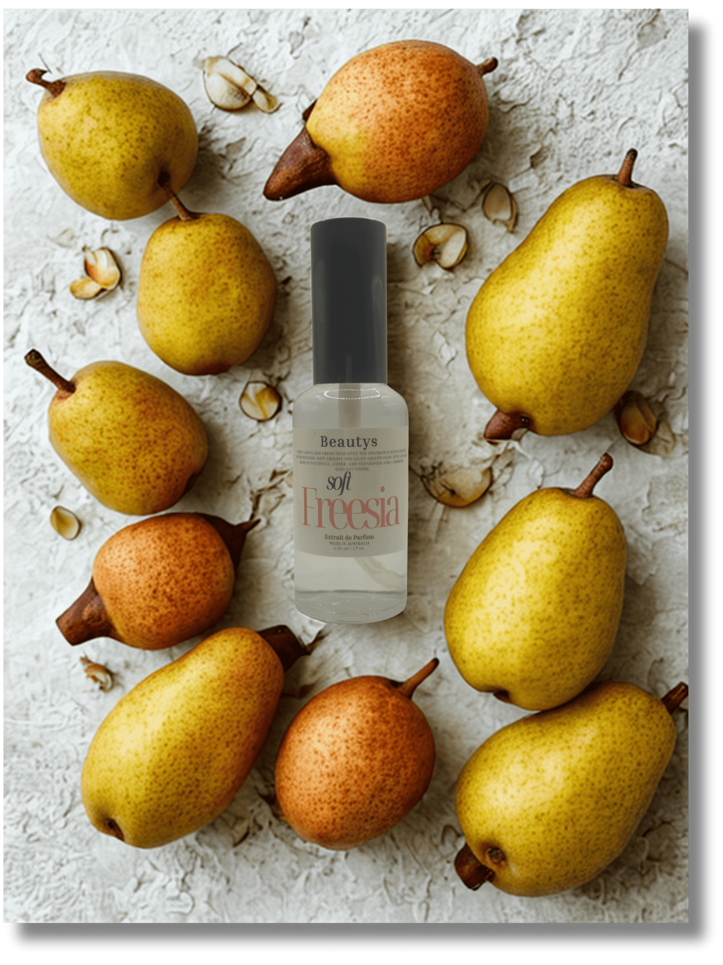 Bottle of Freesia perfume surrounded by pears on a textured surface