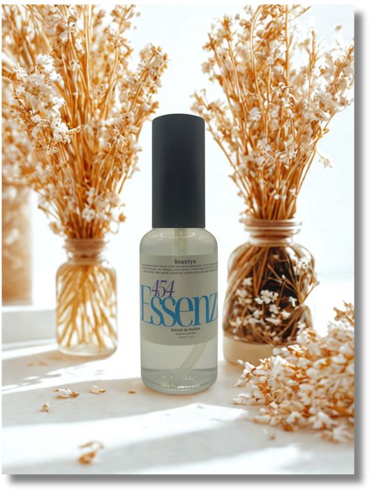 Bottle of Essenz with decorative dried plants on a light background