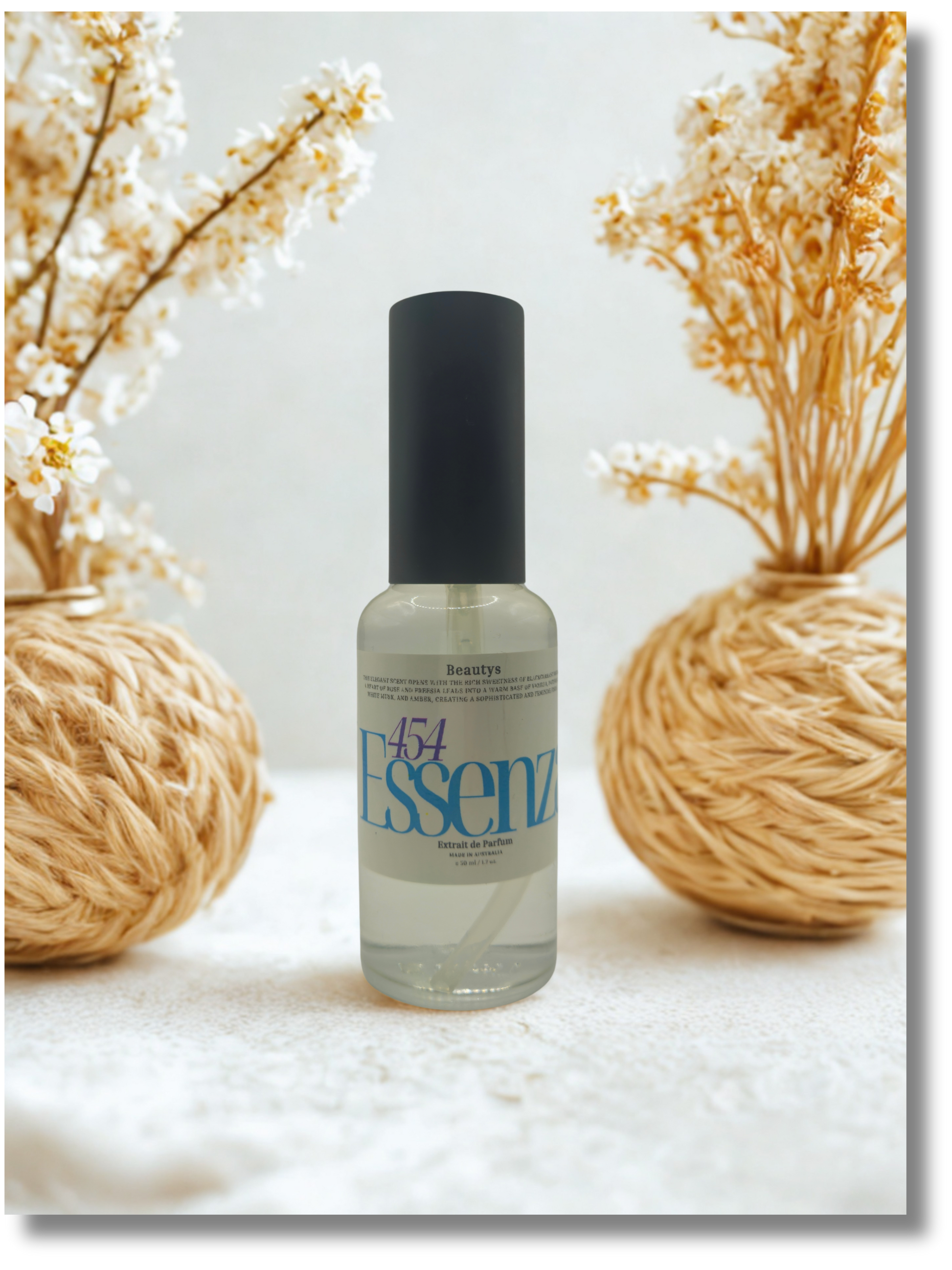 Bottle of Essenz with decorative elements on a light background