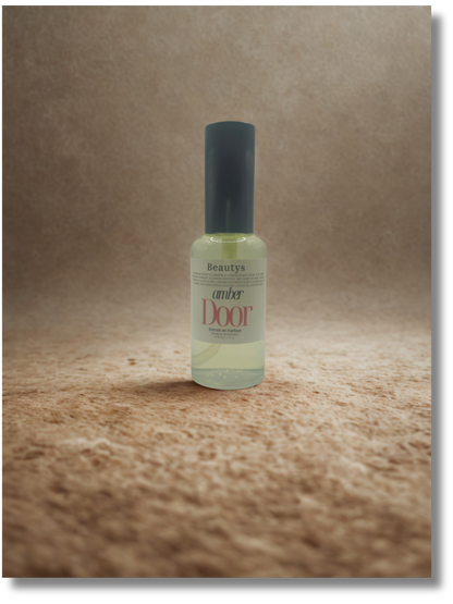 Bottle of 'Beauty's Amber Door' on a textured brown surface