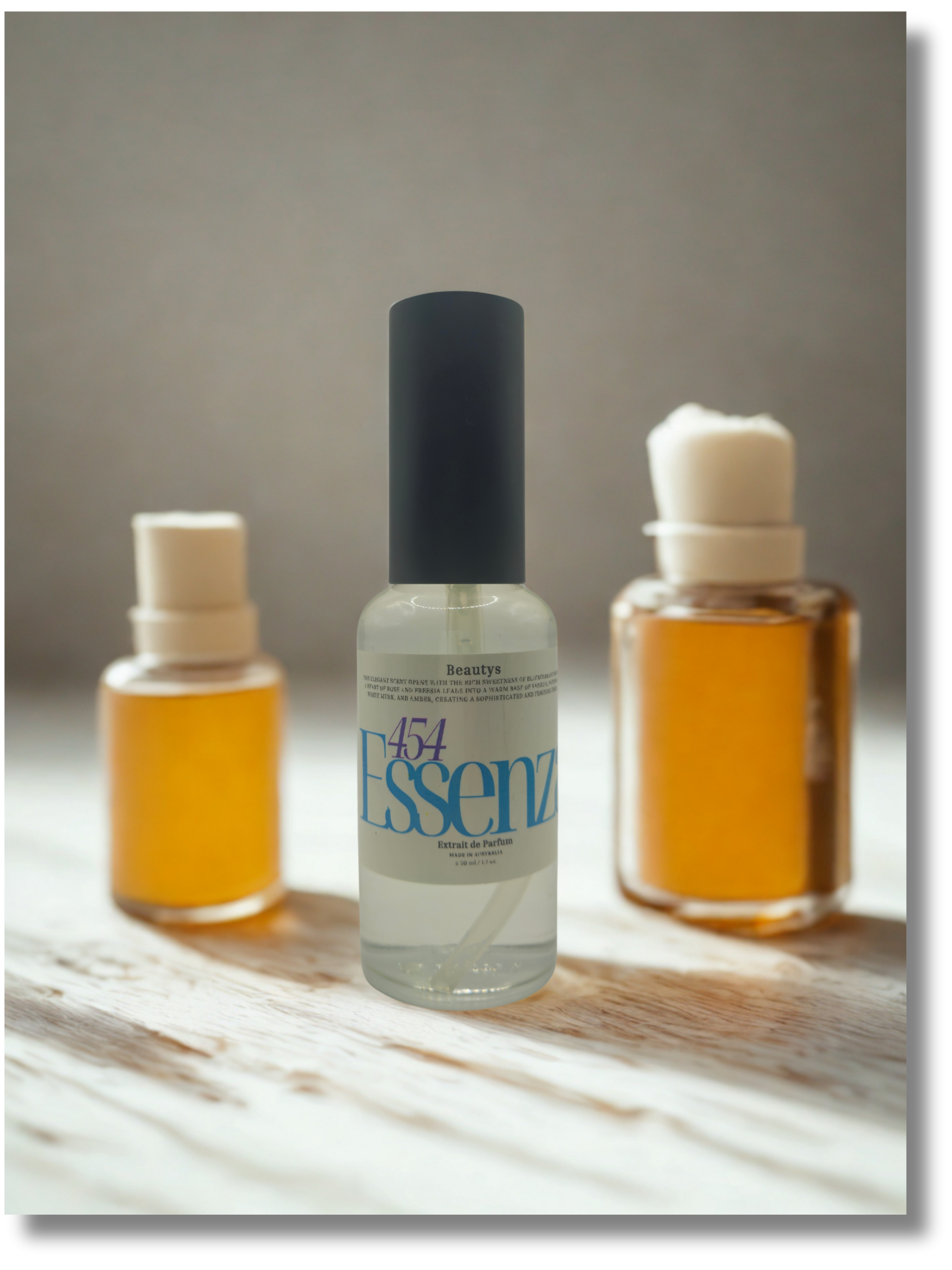 Three bottles of Essenz on a marble surface with a neutral background